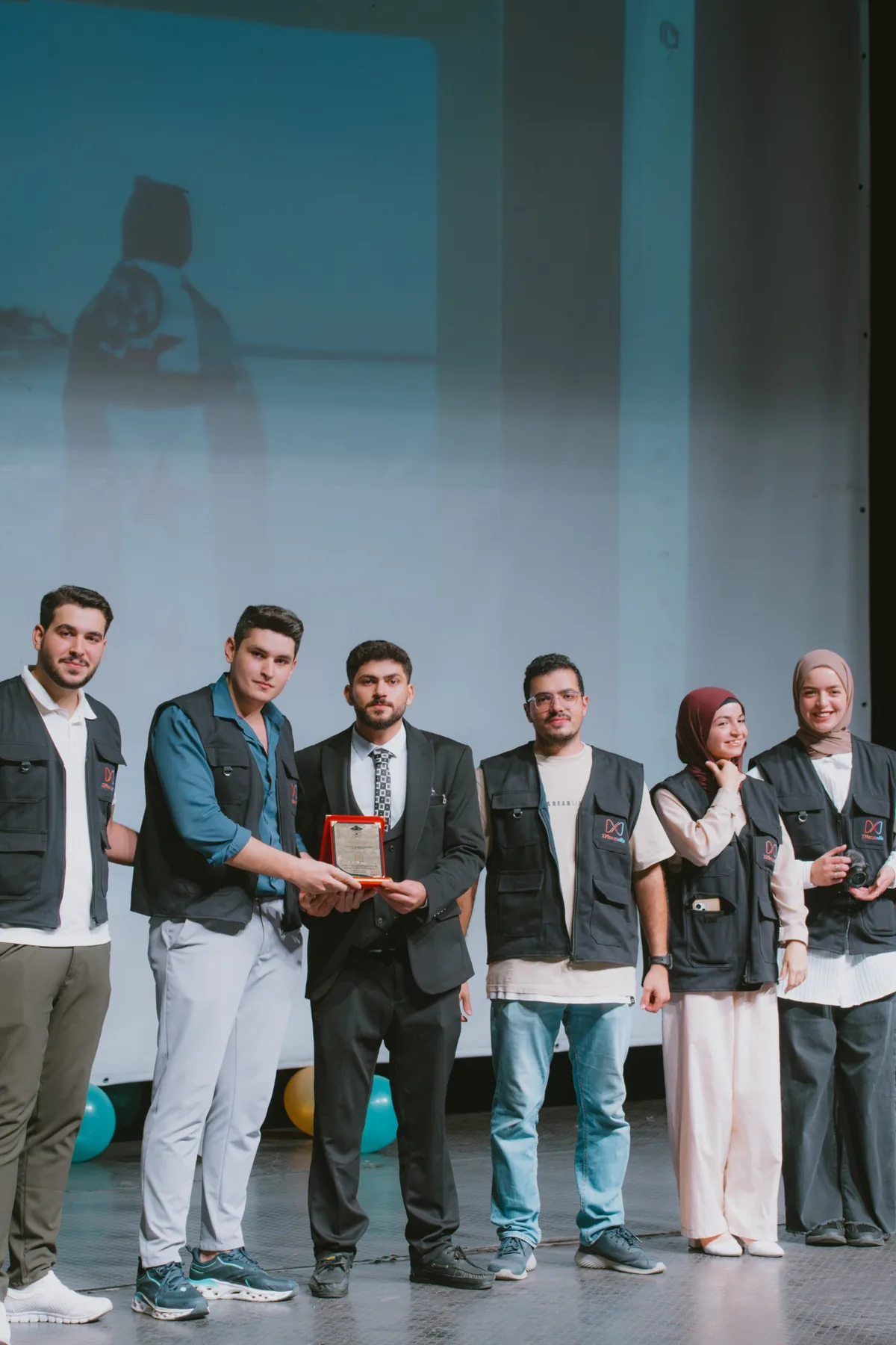 Zakaria with a creative team