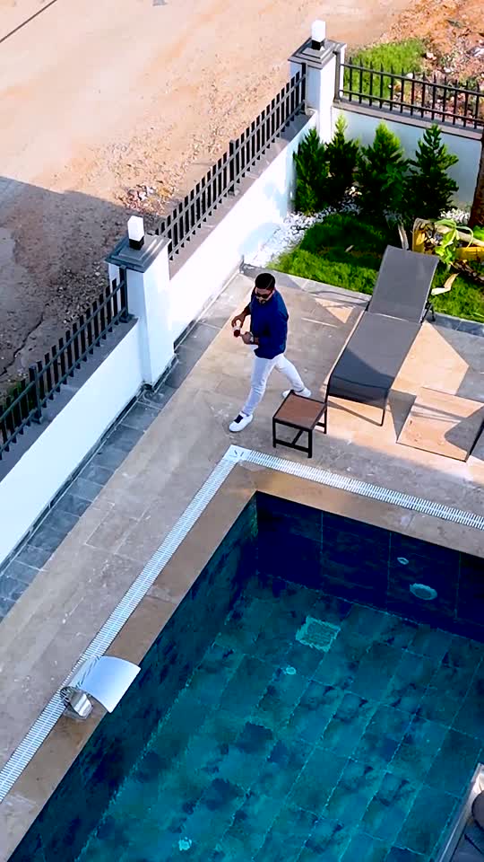 Real-estate content production frame by a pool